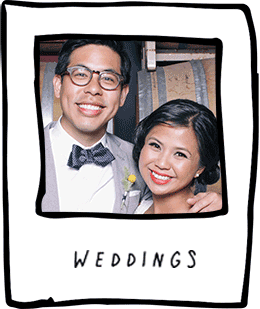 Smiling couple in wedding attire.